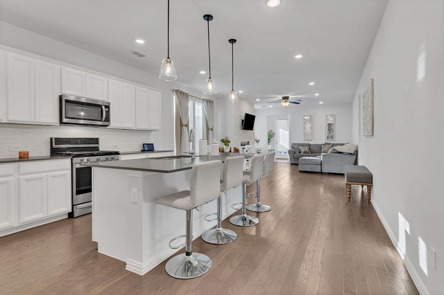 $1000 toward closing costs for this adorable Cape Cod-style cottage. This lovely home is perfect for a young family, offering split bedrooms, beautiful gas log fireplace and a master bath featuring a walk-in shower, soaking tub and large closet.  Kitchen has gas stove and large island with breakfast bar. Updated laundry room has custom cabinets and sink. Custom shelving in all closets. Outside you will find a covered patio with pull-down sunscreens and fence lighting. HOA includes high-speed fiber internet and front yard lawn service. Amenities in Pecan Square are plentiful and include an arena for gatherings, parties and even wedding receptions; three swimming pools, pickleball, basketball and sand volleyball courts; multiple outdoor grills and even a pizza oven!  A fishing pond, biking and walking trails and a community center are all available withing walking distance.  Furniture and window treatments negotiable. New Tom Thumb grocery store one mile away and easy access to I-35 W.  Come take a look, you will fall in love!