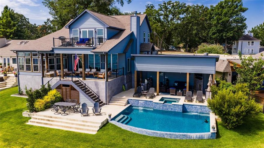 Custom - built in 2018, this stunning home showcases 10-foot ceilings, wide open spaces, and incredible water views throughout. Featuring two spacious living areas and a chef's kitchen with gas cooking, island serving bar, and premium finishes, it's designed for effortless entertaining. The primary suite on the main level offers a serene sitting area , while three private guest suites provide comfort for family and friends. Outdoor living shines with a covered porch equipped with ceiling heaters, a balcony off the upstairs living area, and a cabana, outdoor kitchen, fireplace, TV, and sound system overlooking the sparkling swimming pool.