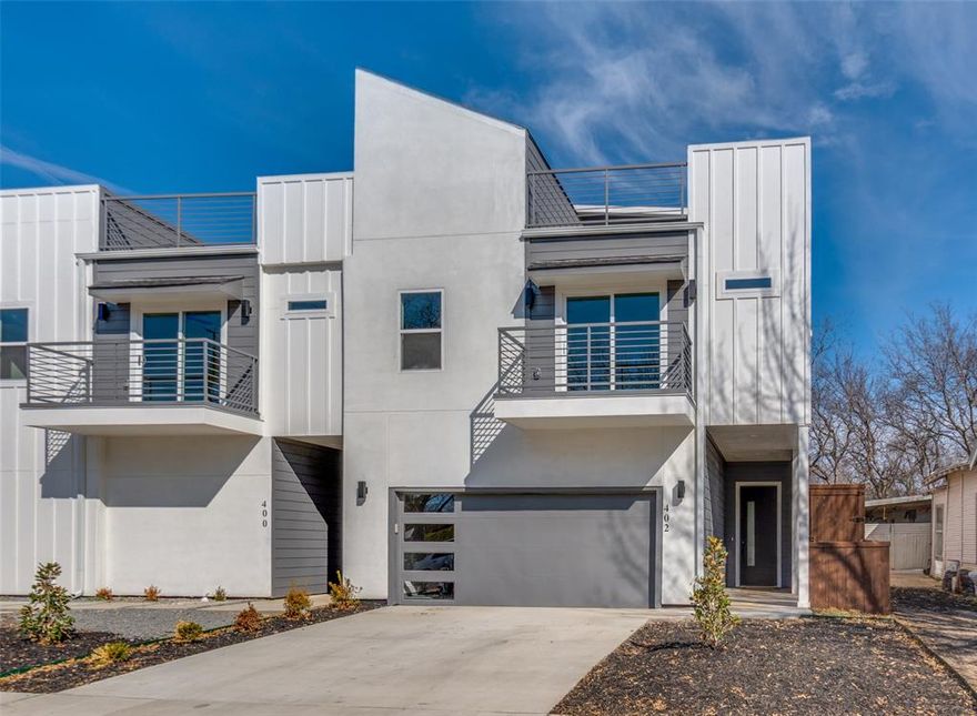 Experience elevated urban living where design, location, and views converge. This stunning 2025 new-construction modern townhome is ideally positioned directly along the Santa Fe Trail, offering a rare blend of nature, recreation, and city energy—all with unobstructed views of the Downtown Dallas skyline. Located less than 10 minutes from the heart of Downtown and just moments from Tenison Park Golf Course, this home delivers a lifestyle few properties can match.

Spanning approximately 2,200 sq ft across three thoughtfully designed levels, this residence showcases soaring ceilings, clean architectural lines, and an open-concept layout bathed in natural light. The gourmet kitchen anchors the main living space with sleek modern cabinetry, quartz countertops, premium finishes, and seamless flow into the living and dining areas—perfect for entertaining or everyday luxury.

The primary suite is a true retreat, featuring breathtaking Downtown Dallas views from the bedroom, dual walk-in closets, and a spa-inspired bathroom with designer finishes that elevate daily living. Secondary bedrooms offer generous space and contemporary design to accommodate guests, work-from-home needs, or growing lifestyles.

At the top, a private rooftop patio delivers panoramic skyline views of Downtown Dallas, creating an unforgettable setting for sunset gatherings, morning workouts, or quiet evenings under the city lights. Additional outdoor living includes a main-level private patio, offering multiple spaces to relax and recharge.

With immediate access to miles of scenic trails, green space, golf, and the city’s top dining, entertainment, and cultural destinations, this home represents a rare opportunity to own a brand-new modern residence in one of Dallas’ most dynamic and rapidly appreciating locations.

Seller to provide a 1-2-10 builder warranty at closing.