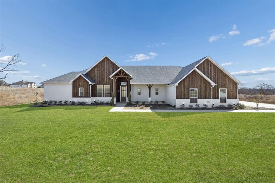 Move-in ready and a must-see! Located in the highly desirable Calhoun Acres community in Azle, this beautifully completed farmhouse-style home sits on a full 1-acre lot and offers 4 bedrooms, a dedicated study, 2.5 bathrooms, and a 3-car garage. Built by Sunrise C&C Construction, home blends quality craftsmanship with thoughtful design throughout. Step inside to an inviting foyer that opens into a spacious family room featuring soaring ceilings, exposed beams, and abundant natural light. The kitchen is the heart of the home, showcasing an oversized quartz island, stainless steel appliances, built-in microwave, and ample cabinetry with upper and lower accent lighting perfect for both everyday living and entertaining. The primary suite is generously sized and includes a large walk-in closet, dual vanities, a soaking tub, and a separate walk-in shower. Additional highlights include perimeter wall foam insulation for energy efficiency, underground utilities, and AT&T Fiber availability. Conveniently located near the elementary school, this home is now 100% complete and ready for its new owners to enjoy peaceful country-style living with modern comforts.