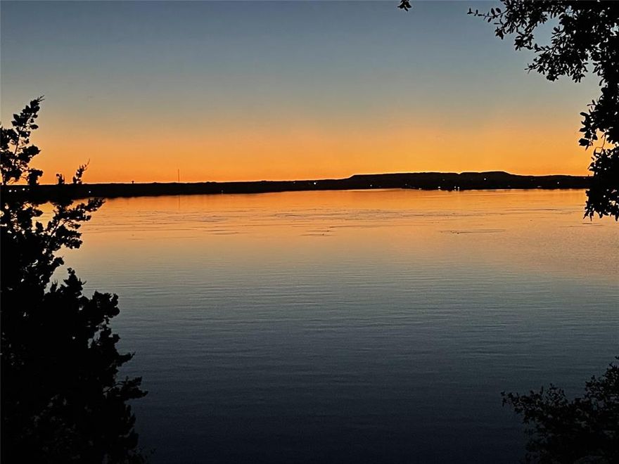 FULLY FURNISHED 3-bed 2-bath located on the wide body of Lake Granbury. MAGICAL WATER VIEWS and DOCK & SLIP IN DEEP WATER! All you need is your toothbrush. Enjoy breathtaking sunsets from the balconies on both levels. Open kitchen featuring large eating bar for entertaining melts into an inviting great room accented by stone wood-burning fireplace. Guest room & full bath complete level 1. Upstairs features a roomy primary bedroom with stunning views, a full bath & another guest room that can be an office. Wonderful dock is where you'll want to spend the entire day. Complete with dual jet ski launch, the oversized covered lounge area boasts of a hut with both power & water for hours of entertaining. This is lake living without the fuss. Charming townhome is located inside DeCordova Bend featuring 2 golf courses, tennis, pickleball, practice range, community pool, full-service club house, marina, RV hookups & full-time security. Don't miss one of the best kept secrets on Lake Granbury!