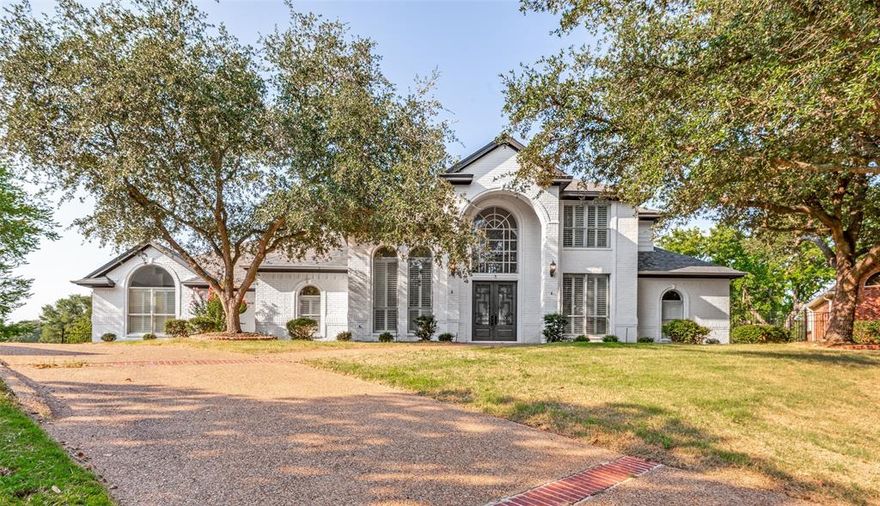 Set on over HALF AN ACRE, this modern mansion-style home rests on a quiet cul-de-sac in the coveted Loch N Green
Village, a serene and community-focused neighborhood. Step into the dramatic double-height foyer with a sweeping
curved staircase leading to two bedrooms and a spacious Jack & Jill bath upstairs.The first floor offers two expansive
living areas with serene views of the private pond and a low-maintenance decked backyard. The cozy, efficient kitchen
with stainless steel appliances is perfectly positioned between the formal dining room and breakfast area. A versatile
guest room or office overlooks the front yard with mature trees. A convenient half bath provides access to the backyard
deck, while a large utility room sits near the oversized three-car garage. Plantation shutters and durable lowmaintenance flooring enhance the first floor throughout. The luxurious primary suite overlooks the pond and features an updated modern bathroom with a spa-like feel and a spacious walk-in closet. Ideally located just minutes from I-30 and W Division Street, with easy access to Downtown Fort Worth, Lake Arlington, Grace Preparatory Academy, and top attractions including AT&T Stadium, Globe Life Field, Six Flags, UT Arlington Planetarium, and River Legacy Parks.