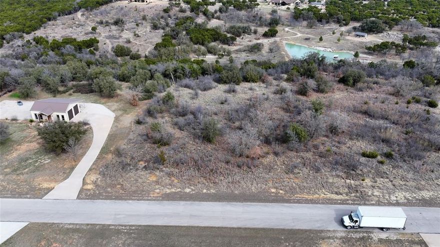 This nearly 2-acre parcel offers privacy, serenity, and the perfect setting for your forever home in a prestigious gated lakefront community near Graford. Located in Palo Pinto County, this approximately 1.9-acre lot, features paved road access within a gated community of high end homes. Electricity and city water are available at the road, city sewer is in place, and mineral rights convey 100%, with title held free and clear. The HOA dues are current, standard utility easements apply, and deed restrictions require a minimum build of approximately 1,800 sq ft with no mobile homes permitted.