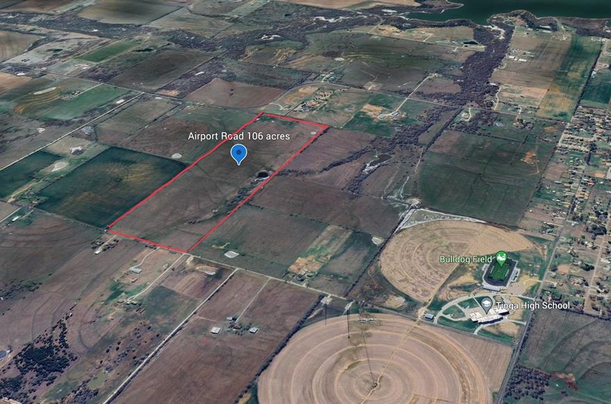 Highly desirable property for personal use or development. <1 mi to Tioga HS & Stadium. <6 mi to proposed DNT extension. Proposed re-routing of 121 will shorten distance & bring retail development with it. Lot has pole barn + 2 tanks from prior use for grazing livestock & hay farming. Recently, native grasses have produced crops of round, square bales. Electricity & fiber cable available. Fire hydrants nearby. Ask Tioga re future water and sewer lines. Old dug well and pump irreparable. Remains of propane tank buried on the south end of property. Old milk barn on southeast corner is dilapidated. Not in flood plain but some drainage occurs across the land in heavy rain. Property is not in city limits but most of it is in Tioga ETJ. Northern portion lies in Lake R Roberts Zoning District.  Ag exemption in place. Survey shows 105.2 acres after deducting .8 acres in road. Option period ends 9-30. Back-up offers welcome. Ask an agent to provide you MLS photos to see many more details!