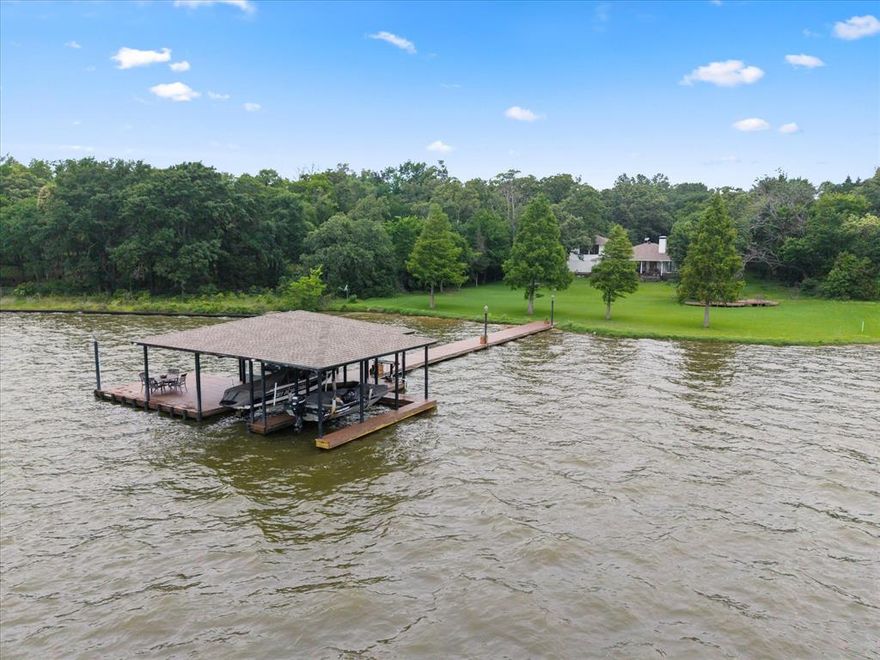 Exceptional Turnkey Lakefront Home on Cedar Creek Lake in the Long Cove Area Are you ready to make memories of a lifetime? - Rare and Expansive Nearly 2 Acre Parcel with 230’ of Lakefront Shoreline and Existing Boathouse Dock! Rare opportunity to own a secluded, oversized waterfront property on Cedar Creek Lake, located just one hour drive from Dallas. Situated on 1.72 acres, this Lakefront property offers wide open waterfront views, exceptional privacy, and endless potential. The existing home features 2 oversized primary bedrooms, 1 bunk bedroom, 2.5 bathrooms, a versatile floor plan, and a fully air-conditioned garage, offering plenty of space for family, guests, or entertaining. The large covered back porch as well as the additional deck porch in the expansive backyard overlooks the lake, providing the perfect setting to enjoy peaceful mornings and quiet evenings in a truly serene environment. Enjoy the direct, private lake access with an existing pier and dock with 2boat slips and a large jet ski slip, all with electric lifts - perfect for boating, fishing, and water recreation right from your backyard. Ideal for a private lakefront getaway, this unique parcel is one of the few available waterfront properties of its size in the area. Don't miss this opportunity to invest in lakefront living at its finest - privacy, space, and stunning views all in one exceptional property. Call today to schedule your private viewing!