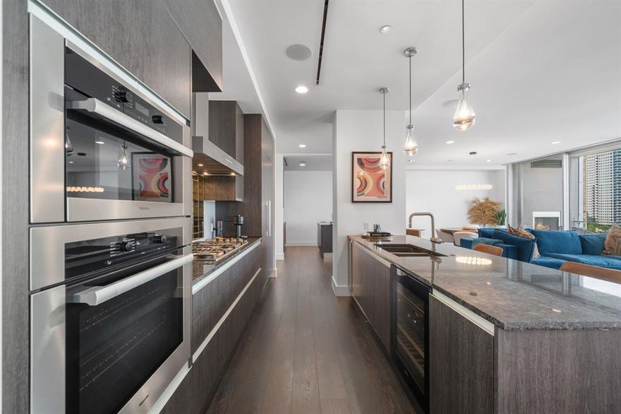 LIVE ABOVE IT ALL.
Experience Modern Elegance in this stunning residence located in the vibrant heart of Harwood District in Uptown Dallas, designed by world-renowned French Architect Jean-Michel Wilmotte. Minutes away from Park Cities, American Airlines center, Love Field and surrounded by the city's finest dining and nightlife. This 3-bedroom, 3.5 bath condo showcases panoramic 360-degree views of Downtown Dallas from 2 expansive private terraces- each featuring a fireplace.
Crafted with designer finishes and elevated materials throughout, this home features marble and wood flooring, custom closets, and power shades for effortless luxury. The open-concept living space includes a cozy living room with fireplace, gourmet kitchen, a wet bar off the formal dining area all designed for grand entertaining and everyday comfort. Other features include a walk-in pantry with mud room, dedicated suede-padded media room. Surround sound throughout. The primary suite is a luxurious retreat with a see-through  fireplace leading into a spa-like bathroom. Both guest bedrooms offer en-suite baths and refined privacy for family or visitors. Added features include a private office or retreat off the Primary Bedroom along with a 4 car garage. Unmatched Building Amenities include- 24-7 valet and concierge, car wash service and EV charging.Exclusive residents only state of the art Spa, fitness center, yoga studio, 2 junior olympic size pools with pool side lounging. Hot tub, wine cellar and tasting room, social lounge, club room, gated garage, dog park, direct access to Katy trail, secure access for garage and elevators along with a full time staff.