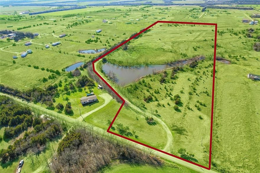 AG EXEMPT 33 ACRES Close to Lake Lavon in Farmersville Texas! Tree lined private road leads to a tranquil spring fed 6 acre lake stocked with fish. Build your dream home or develop and entire neighborhood. Ideal for investors, farmers, hunters, or families seeking a tranquil retreat. Located on the Collin County & Hunt County line one mile from Highway 380 in the rapid growth corridor outside Farmersville close to proposed Collin County loop and proposed Highway 380 bypass. Road frontage on FM 1121. Outside the city limits. No zoning. No known restrictions. Cleared level pasture with hay meadow for farm animals. Improvements on the land include 2 septic systems, 2 water meters, 4 electic meters. A manufactured home is on property built with 2 x 6 walls, central heat & air, dual pane windows & steel roof. Second residence on the propety is 840 square foot including one bedroom +1.5 bath + full kitchen. Covered carport for two vehicles. No flood plain. Land can be cleared at buyers request.