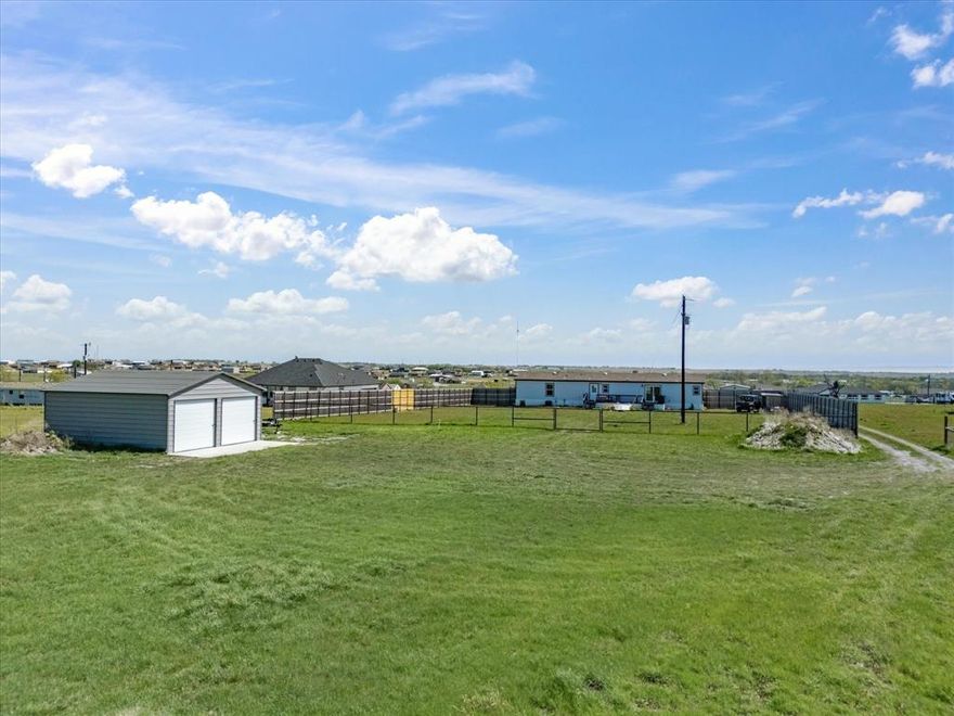 JUST LISTED Nearly 3 acres with a charming spacious well maintained doublewide manufactured home has 4 bedrooms, 3 bathrooms, two living areas, and a dedicated office, providing plenty of room for comfortable country living.  Includes an extended open back porch, the perfect spot to enjoy quiet country evenings with wide open views. The property is fully fenced and gated, making it ideal for livestock or hobby farming. Bring your horses, cows, chickens, or ducks.  The land features 5 foot no climb fencing in the back, a drive through gate, and 8 foot partial privacy fencing on both sides. Additional highlights include a storm shelter designed for up to 15 people and a small stable for livestock. 

The property also includes a 22x25 A frame engineered and certified workshop garage, set on a concrete pad and equipped with a 36x80 walk in door, a window, and two 9x8 roll-up doors, offering excellent space for equipment, projects, or storage. 

A rare opportunity to enjoy country living with convenient access to DFW... more details and photos coming soon!