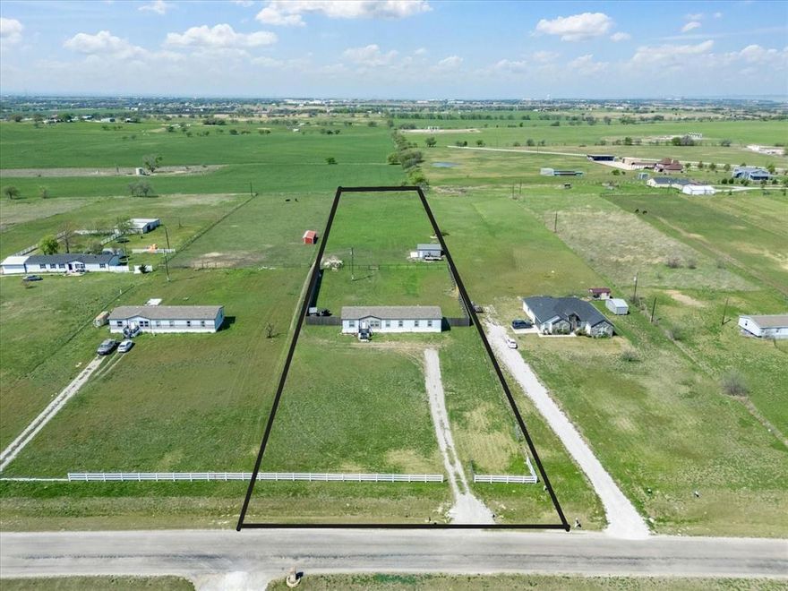 Enjoy country living with convenient access to DFW!! Nearly 3 acres with a charming spacious well maintained doublewide manufactured home has 4 bedrooms, 3 bathrooms, two living areas, and a dedicated office, providing plenty of room for comfortable country living.  Includes an extended open back porch, the perfect spot to enjoy quiet country evenings with wide open views. The property is fully fenced and gated, making it ideal for livestock or hobby farming. Bring your horses, cows, chickens, or ducks.  The land features 5 foot no climb fencing in the back, a drive through gate, and 8 foot partial privacy fencing on both sides. Additional highlights include a storm shelter designed for up to 15 people and a small stable for livestock. 

The property also includes a 22x25 A frame engineered and certified workshop garage, set on a concrete pad and equipped with a 36x80 walk in door, a window, and two 9x8 roll-up doors, offering excellent space for equipment, projects, or storage. 

A rare opportunity to enjoy country living with convenient access to DFW.