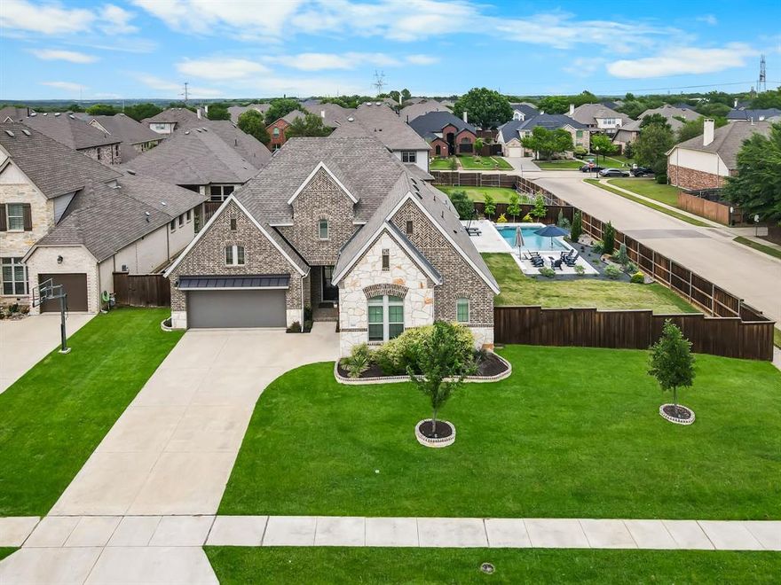 Pool days, firepit nights, and effortless single-story living—this gorgeous home on a premium corner lot in Highland Village delivers on every level! This thoughtfully designed 4-bedroom, 3.5-bath home offers light-filled interiors, an open-concept layout, and true move-in ready ease in one of the city’s most sought-after communities.

The kitchen is a true centerpiece, featuring high-end appliances, a large island, ample cabinetry, and generous prep space—perfect for everyday living and entertaining. A unique bonus: electrical in the pantry adds convenience for small appliances and extra functionality. The kitchen flows seamlessly into the main living and dining areas, creating the open floor plan buyers are searching for.

The single-story layout is a standout, offering both convenience and long-term livability. The private primary suite feels like a retreat, complete with a spa-style bath and dual walk-in closets. A secondary bedroom with an ensuite bath near the garage is ideal for guests or multigenerational living, while two additional bedrooms provide flexibility for a home office or fitness space. A built-in Murphy bed in this bedroom conveys, adding versatility and value! Custom closets throughout—because everything deserves its place! The generous bonus room is perfect for movie nights, game days, and more.

Step outside to your own backyard retreat, where a sparkling pool, extended patio, and firepit create the perfect setting for relaxing or entertaining. Two raised garden beds just off the patio make it easy to grab fresh herbs and vegetables. The corner lot offers one of the larger yard footprints in the neighborhood, and the three-car garage provides ample space for vehicles, storage, and hobbies.

Enjoy quick access to shopping, dining, trails, and Lake Lewisville’s boating and sunset views—all within a community known for highly desirable schools. Single-story, pool, corner lot, and lifestyle—this one truly stands out!