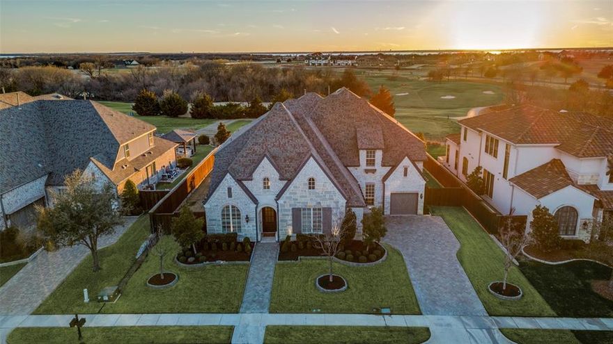 STUNNING Custom built Huntington home located in the coveted GATED Balmerino of The Tribute. Luxury exudes the minute you step inside with thoughtful architectural details in every space. Sitting on over third acre premium golf course lot with brick and stone elevation, hand laid stone driveway and arched windows for timeless curb appeal. Home has 5 beds, 5.3 baths, 3 car epoxied garage, study, first floor media and oversized 2nd floor game room. Grand entry has groin ceilings with upgraded lighting and wide plank wood floors that flow throughout… setting the tone for elegance that continues through the home. Chef's dream kitchen has Wolf appliances including 6 burner gas stove, built in refrigerator, double ovens and pot filler. Home has 2 wet bars with beverage fridges on each floor. Living room is bright and airy with soaring ceilings, wood beams and a beautiful fireplace that centers the space. Study boasts wainscoting, built ins and upgraded lighting creating the perfect private home office. Primary comes complete with bump out for sitting area and spa-like ensuite bath with double vanities, oversized free-standing tub, Baja shower & custom California closet. Wide plank wood flooring and plantation shutters flow throughout the home. Second floor is the ideal floor plan with oversized game room, second living room, built in desks, and balcony with breathtaking views. All bedrooms have en-suite baths and spacious walk-in closets. Your very own oasis awaits with INFINITY pool and spa overlooking The Tribute Golf course. Truly an entertainer's dream backyard with outdoor kitchen and covered patio with fireplace. Outside entry pool bath is an added bonus! Screens on the back patio and balcony were recently installed making these spaces easy to enjoy all year long. Did we mention the SUNSET golf course views?! You DO NOT want to miss out on this one-of-a-kind DREAM home.