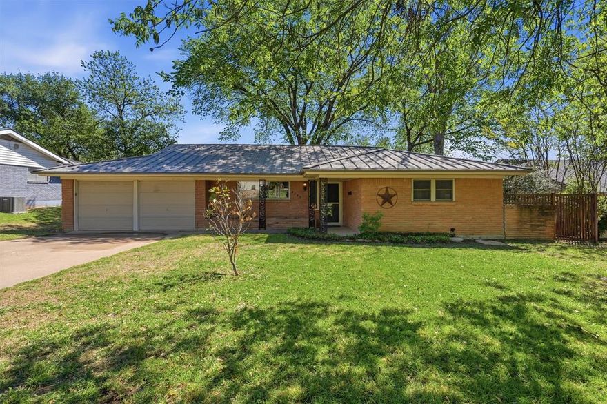 Welcome to this charming 4-bedroom, 2-bath ranch-style home located in Brooks-Moreland Addition of Benbrook. Built in 1959 and offering 1,912 square feet, this single-story property sits on a spacious, tree-filled lot just under a quarter acre.  Inside, you’ll find a functional layout with a generous living area anchored by a cozy brick fireplace with gas logs, perfect for relaxing or entertaining. The kitchen features an eat-in dining space, electric cooktop and oven, and is plumbed for gas—offering flexibility for future upgrades. A dry bar and decorative lighting add character and convenience.  The home offers four well-sized bedrooms, including a primary suite with built-in cabinetry and ample storage. Flooring includes a mix of wood and ceramic tile throughout.  Step outside to enjoy the covered patio and mature trees that provide shade and privacy, creating a peaceful backyard setting. Additional highlights include a metal roof, central HVAC, skylights, rain gutters, and an attached garage with opener.  Located within Fort Worth ISD and just minutes from local amenities, this property offers a great opportunity to own a well-maintained home in a desirable, established neighborhood. Upgrades include, foam insulation, metal roof, 4-ton Trane HVAC.  Schedule showings today through BrokerBay.