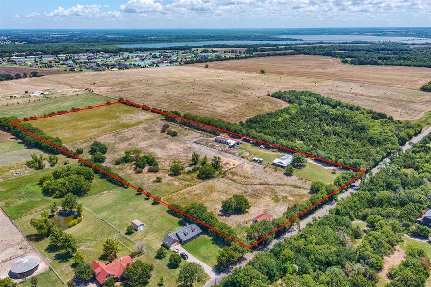 This 16.4-acre Princeton Ranch presents a rare investment opportunity, boasting over 500 feet of frontage along CR 491 and convenient access to US 380. Situated within the Princeton ETJ and designated as Suburban Living in the City of Princeton's future use map, the property is strategically positioned next to a planned residential development for 300+ single-family homes. The property currently operates as a horse ranch, featuring a charming 3-bedroom, 2-bathroom main home, an older but well-equipped main horse barn with 17 stalls and 4 tie stalls, as well as two additional hay & equipment barns. Positioned just beyond the city limits with no known restrictions, this prime piece of land offers a promising future for suburban or estate living. With 1 acre designated as a homestead and the remaining 15.4 acres benefiting from an agricultural exemption, this property presents investment opportunity and residential development with endless possibilities.
