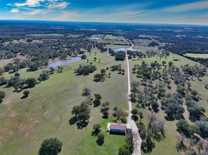 This 253 acre Texas ranch invites you to experience the joy of country living Spanning across rolling hills it seamlessly blends nature and privacy The centerpiece is its 4 ponds two fed by a reliable well offering a constant water source for both recreation and practical needs Imagine lazy afternoons casting a line into the waters against the backdrop of the Texas sky painted in hues of orange and pink as the sun sets Cross-fencing divides the property into lush pastures and charming forested areas catering to equestrian enthusiasts nature lovers or those seeking the tranquility of wide open spaces Ideal for ranchers the cross-fenced pastures are ready for livestock with ample space for cattle to graze freely The thoughtful design efficiently manages the land for agricultural pursuits making it a haven for those passionate about farming or ranching. Inlcudes agexemption well water outside city limits 3bed 2bath foreman house with detached garage and shop