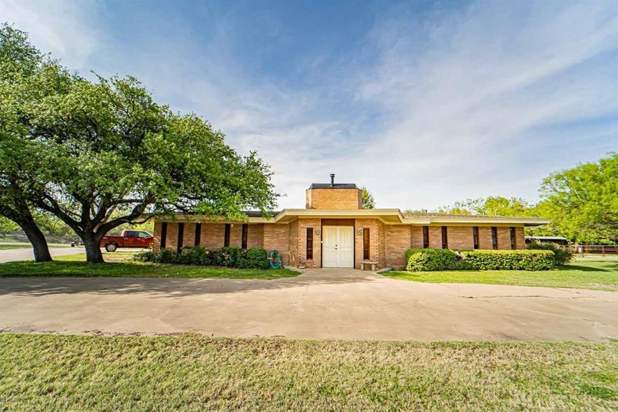Unique! Unusual! Nothing like it in town! A pleasant one of a kind built for family comfort, and living enjoyment in a rather Mid Century modern type style! There are 4 actual bedrooms with nice closets, but there are also two different rooms to be used as offfices for work from home couples or libraries or media rooms! What ever you desire for these spaces! Featured in the foyer is a brick wall that is the back side of the WBFP located in the naturally lighted huge family room with beamed ceiling and indirect lighting. The ample windows look out on the back yard with a feel of being in the country. There is an area for formal dining with a wet bar, counter and storage. Close by is the wonderful kitchen boasting custom made cabinetry, tons of work space and storage and lots of extras including a greenhouse window over the double sink. A breakfast bar and counters are quartz or silestone. Electric stove with big oven but also an additional large oven. If the cook prefers gas, there is also connection for that.A nice bay window in the breakfast space area. Utility room hosts a big sink, pantry, and even more storage. There is a half bath in this area. The bedroom wing features 3 of them that are about the same size with great closets. The hall bath is beautiful with 2 sinks and custom cabinets.The primary bedroom with an outside door and sitting porch, is private at the end of the hallway with walk-in closet, ensuite bath with another walk-in closet, large tile shower, vanity. There is a great patio across the back of the house entered from the living room and other areas and is perfect for outdoor entertaining. Flooring is ceramic tile, parquet, and carpet. 3 CHA Units, 2 water heaters. There are just too many wonderful and useful perks in this house to list, so make appointment to see it with your favorite realtor yourself!