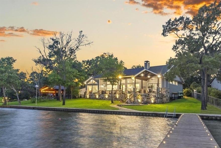 BEAUTIFUL East-Facing SINGLE story; Deep (~10’) at dock & Open water views with 140’ lake front. One of few built in last 5 yrs on OPEN water, priced below $2M. Floor-to-Ceiling Pella windows & doors. Access Game Room, via mahogany 4’ * 8’ barn door, hours of family time playing Pool, Ping Pong, Shuffleboard, Foosball & Arcade games. Outdoor living faces East for enjoyment when S & W facing homes are intolerable in scorching TX summers. Huge open Family-Dining-Kitchen with shed ceiling that reaches 14’ embracing the lake, trees and sky. Massive kitchen with 10’ center island, walk-in pantry, commercial-grade gas cooktop, double ovens, MW, ice maker & wine cooler. Foam Encapsulated Insulation. Boat Dock accommodates Boat + 2 PWCs lifts; $8K Touchless Boat cover; diving board & large seating area. Sea wall & walkway. Stone firepit. Lots of grass for games & pets. Private & gated with extensive concrete for pickleball & numerous cars.  Trailer storage.  Seller financing considered.