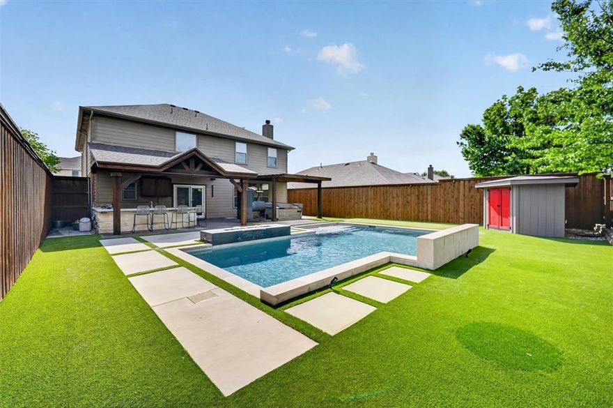 Stunning 4-bedroom home with a resort-style backyard & generously sized living spaces throughout! Thoughtfully upgraded & designed for both everyday comfort and unforgettable entertaining, this home truly has it all. Step outside to your private backyard oasis featuring a pool complete with two water features, heating and chilling capabilities, and a maximum depth of 5.5 feet. Relax by the built-in natural gas firepit or unwind under the added covered pergola. The backyard has been enhanced with low-voltage exterior lighting that creates a true nighttime retreat. The remodeled outdoor kitchen is a showstopper, featuring premium built-ins including a Primo grill & Le Griddle—perfect for hosting gatherings year-round. The entire backyard has been upgraded with turf for low-maintenance living, along with a 260+ sq ft high-performance slit-film putting green with four holes. A storage shed adds convenience for tools & seasonal items. Inside, the home offers a private front office and a spacious formal dining room. The open-concept living area flows seamlessly into the kitchen, which features an island, stainless steel appliances, stylish lighting, breakfast bar, eat-in dining space, abundant cabinetry, and an accent wall. Upstairs, you’ll find a massive game room with a dedicated storage closet and four oversized bedrooms, including a truly expansive primary suite with a beautifully updated ensuite bathroom and an impressive 11x11 walk-in closet. Recent interior updates include replaced carpet, fresh paint throughout most of the home, and a new living room fan. Additional features include multiple storage closets throughout and built-in shelving with overhead storage in the garage. Enjoy access to community amenities including a pool, park, and playground. Conveniently located near major highways and zoned to highly sought-after Frisco ISD schools. Don't miss your chance to enjoy this stunning low-maintaince outdoor living & pool by summer time!
