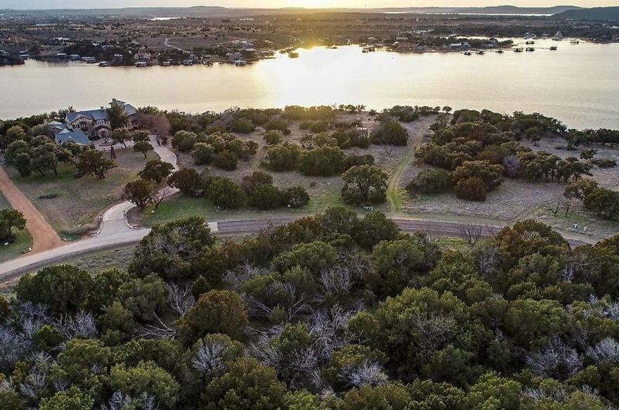 Gorgeous views from sunrise to sunset on this stunning 1+ acre waterfront lot in the prestigious subdivision of The Ranch at Possum Kingdom Lake. This lot sits on some of Possum Kingdoms most iconic cliff lines. Build your dream home on the spacious lot and enjoy the picturesque views of the main channel of Possum Kingdom Lake. Imagine an infinity pool overlooking the lake and watching some of the most beautiful breath taking Texas sunsets from your own backyard. Exceptional amenities offer owners access to over 1100 acres of common area for those ATV-UTV explorations, skeet shooting range, sports complex with tennis courts, volleyball, jogging path, bike path, walking trails, equestrian center, riding trails, stables, marina and home of the famous million dollar swimming pool. Subdivision also offers community dock, fishing, boat ramp & more! You will fall in love with The Ranch as soon as you drive through and see the amazing views, amenities and beautiful water features throughout!