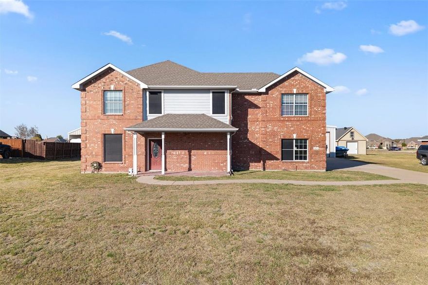 This charming two-story home features 4 bedrooms and 2.5 baths in roughly 2,331 sq ft of living space in the peaceful community of High Meadow Estates. Sitting on a 1.08-acre lot with no added taxes of PID, MUD or HOA. The heart of the home boasts an open-floor layout with a well-appointed kitchen including an island and eat-in area, flowing into a welcoming living room anchored by a wood-burning fireplace. Upstairs, the primary suite offers a tub, separate vanities and walk-in closet, while three additional generous bedrooms share a full bath. Outside you’ll find a 45'x25' detached shop building with roll-up door with power connected —ideal for a workshop, mechanics bay, RV storage, hobby studio, or additional storage. The large lot provides ample space for outdoor recreation, future pool. This is acreage living within reach of Wylie and Rockwall, combining comfort, utility and flexibility.