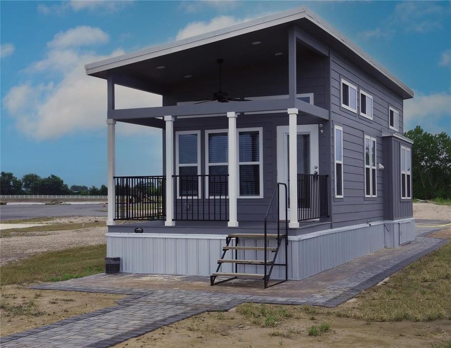 Enjoy lakefront living at its best in this charming tiny home located in the gated Peninsula Point RV & Tiny Home community on Richland Chambers Lake. Situated on a premium waterfront lot just three lots from the boat ramp and clubhouse, this property offers convenience and beautiful lake access. The 5-year-old Travis model by Platinum Cottages features quality construction and a thoughtfully designed interior. Outside, the property includes an upgraded concrete pad, attractive paver driveway, and a walkway leading to your private dock—perfect for fishing, boating, and relaxing by the water. Peninsula Point offers great amenities including a community pool, clubhouse, and boat ramp. Ideal as a weekend lake retreat, vacation rental, or low-maintenance getaway. Rare opportunity to own a lakefront tiny home with private dock on Richland Chambers Lake.