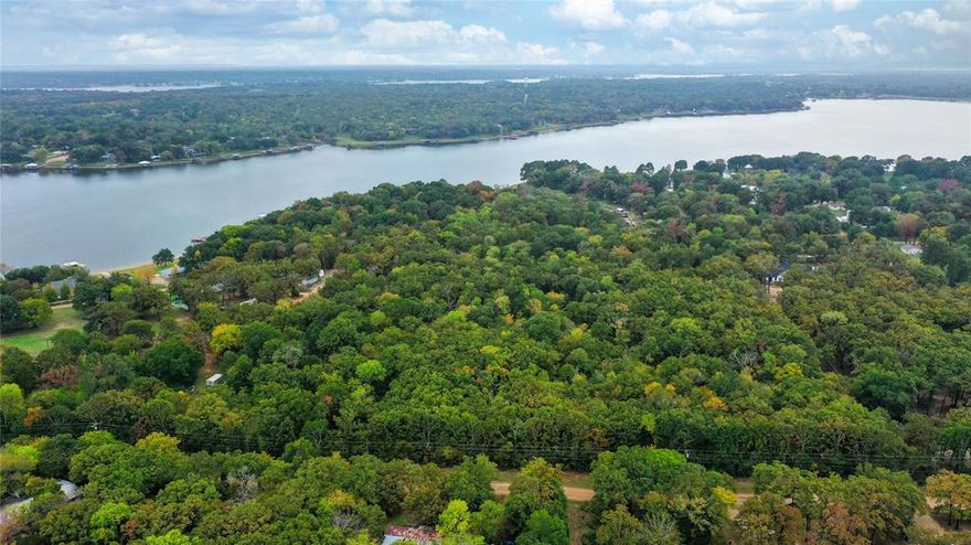Nestled away from the water's edge of Cedar Creek Lake, this unique 10+ acre property backs up to the end of a channel, which gracefully transforms into a meandering creek that winds through the very heart of this expansive property. Plotted for 17 lots and sitting with 900 feet of road frontage, it is ready for a charming residential community or perhaps an exclusive enclave of custom-built homes, RV park or even a tiny home community, each with their own unique slice of paradise. Whether you're considering a serene personal retreat, a real estate investment, or a community development project, this 10+acre gem at Cedar Creek Lake is the canvas of your dreams.