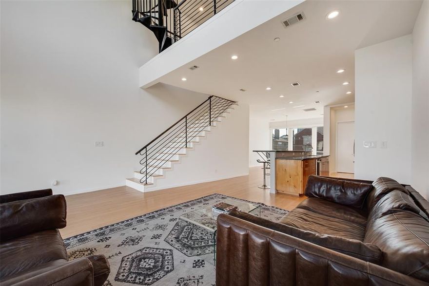 Stylish downtown Fort Worth loft with fresh updates throughout, including new interior paint and lighting. The open-concept main living area features soaring ceilings, oversized windows for abundant natural light.The kitchen connects seamlessly with the living space, offering granite counters, bar seating, stainless steel appliances, and plenty of cabinet storage for a functional yet inviting design.
This flexible floorplan includes a bedroom and ensuite bath on the main level, perfect for guests or a home office. Upstairs, the spacious loft-style bedroom offers privacy and includes a large ensuite bath with a jetted tub and separate glass-enclosed shower.
Enjoy skyline views from your private rooftop deck—an ideal spot for entertaining, relaxing, or catching the Panther Island fireworks. A two-car garage with EV charging adds everyday convenience to this lock-and-leave lifestyle.
With thoughtful updates and a prime location in the heart of downtown, this property blends urban style with modern comfort.