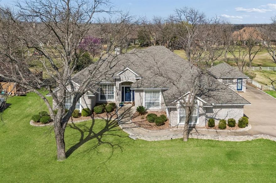 Located in the Pecan Plantation community of Granbury Texas in Hood County and zoned to Granbury ISD, this 3 bedroom, 2 bathroom residence offers approximately 2,352 square feet of single story living positioned along the 10th tee box of the Nutcracker golf course. Located just off Hwy 377 with convenient access to Historic Granbury Square, Lake Granbury, 2 airstrips (Pecan and The Landings), dining & shopping while maintaining the amenities of a gated golf course community. Designed for open concept efficiency and natural light, the floor plan connects the living, dining and kitchen areas for everyday living and entertaining. The fully remodeled kitchen offers shaker style cabinetry, granite countertops, tile backsplash, hardwood flooring, walk-in pantry and double ovens. If you are searching for golf course homes in Granbury Texas within the gated Pecan Plantation community near Lake Granbury, this layout supports both functionality and long term value. Interior highlights include wide plank hardwood flooring, 10 foot ceilings and a remodeled guest bathroom with tiled walk-in shower and frameless glass. The split bedroom layout positions the primary suite separately from secondary bedrooms with dual closets for storage. Buyers comparing homes in Granbury Texas within the Pecan Plantation golf community may appreciate the updated interior and golf course setting. Outdoor living includes a screened patio and covered seating area overlooking the golf course and fenced backyard shaded by 9 mature pecan trees. A detached finished structure with heating and air conditioning provides flexible space ideal for a private office or she shed, with square footage separate from the main residence. Bonus features include: 3 car garage with epoxy flooring, Class 4 impact resistant roof (2025) and Orchard water for irrigation use. This home presents a balanced combination of updated interiors, golf course positioning and established Pecan Plantation living in the Granbury market.