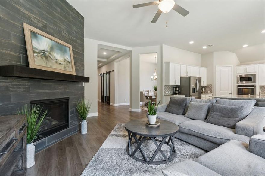 This spacious 5 bedroom, 4 bathroom home seamlessly blends style, comfort, and functionality, offering the perfect layout for modern living. With 4 bedrooms and 3 baths conveniently located downstairs, the home provides both privacy and accessibility for family and guests. Step inside and be welcomed by soaring tray ceilings and a bright, open-concept floor plan designed for everyday living and effortless entertaining. At the heart of the home, the chef’s kitchen boasts a massive island, elegant finishes, and abundant storage—ideal for gatherings big or small. The kitchen flows seamlessly into the breakfast area and living room, while the formal dining room offers an inviting space for special occasions. Working from home is easy in the dedicated office, beautifully accented with modern sliding barn doors. A versatile flex room near two bedrooms and a full bath makes the perfect kids’ zone, guest retreat, or in-law suite. Upstairs, a striking wood and wrought iron staircase leads to a private retreat featuring a spacious game room, fifth bedroom, and full bath—a great space for teens, guests, or family fun. Enjoy outdoor living on the large patio overlooking the peaceful backyard, perfect for evening relaxation or weekend barbecues. Located in Denton ISD and zoned to the highly acclaimed Guyer High School, this home offers not only a prime location but also premium upgrades and custom features you won’t find in a standard builder package.