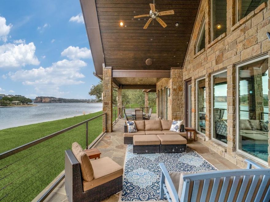 See to believe!  Enjoy this gently sloping lawn onto a rare sandy beach in smooth no-wake water, allowing you to beach your boat and watercraft just a short walk directly in front your home. From there, & from the elevated covered patio that runs the full length of the home, you have amazing views of famed Hells Gate & the surrounding bluffs, with front row seats to the spectacular Fourth of July fireworks, iconic Hell’s Gate cliff diving, & serene glassy deep water.  Built in 2012 to maximize the water features and efficiently use the interior space, the one-level ranch-style residence offers an open great room, dining, & kitchen with an architecturally compelling vaulted ceiling, anchored by a wall of windows across the length of the home, bringing the lake indoors year-round. Double glass entry doors, beautiful cabinetry, 8’ tall doors, rich wood floors, 7” baseboards & 10' high ceilings throughout the home show the home was built to a higher standard. The oversized primary suite features full lake views & the junior master bedroom offers a private en-suite bath; and generously sized bedrooms 3 & 4 share a third full bath. A spacious laundry and pantry room includes a 10’ long countertop, washer and dryer, and a second refrigerator, ideal for extra food & supplies for large gatherings. This resort-style property is accessed through an electronic gate at the road and features a concrete circular driveway winding through secluding trees. The garage connects to the home via a porte-cochère, which provides additional covered parking. The outdoor living area is fully equipped with a built-in grill, speakers, and television—perfect for entertaining and watching your family and guests’ activities across the lawn and in the water.  Keep your boat and waverunners a short ride away at Bluff Creek Marina (let them handle the hassles and expense of boat dock ownership!). All furnishings and water toys are available for purchase, offering a true turnkey lakefront lifestyle.