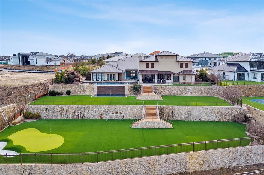 Experience true Indoor Outdoor Living in this exquisite hilltop home on 1-acre lot in gated, guarded Hills of Kingswood. Incredible views from breathtaking floor to ceiling windows of the living room onto the 2-level Infinity Edge pool with grotto & spa leading down to fully turfed lawn with putting green & sandtrap. Entertain friends & family in the opulent Casino Royal inspired bar and game room with retractable metal doors leading to an outdoor living area that includes outdoor AC system, built-in grill & outdoor fireplace. Inside kitchen boasts La Cornue range & hood, large entertaining island and prep kitchen. Coffee bar leads to formal dining featuring a humidity controlled wine room with glass doors. Indoor Basketball Court with wet bar and separate exercise room for the ultimate sports lifestyle. Serene primary suite features fireplace, hidden projector tv, glass doors leading to pool, luxurious spa-like bathroom with his and hers custom closets and access to secondary office.