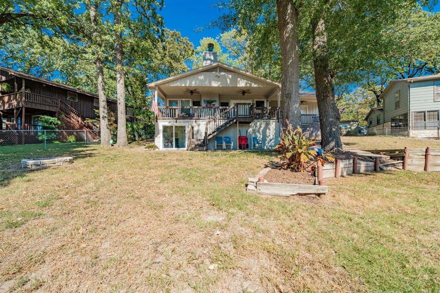 Airbnb ready!!  Set on the shoreline of Cedar Creek Lake, this fully furnished 4-bedroom, 3-bath home blends comfort, function, and investment appeal. The board-and-batten exterior complements a bright, open-concept floor plan anchored by a wood-burning fireplace and vaulted ceiling. The living room is filled with natural light and flows into a well-equipped kitchen featuring abundant cabinetry, a breakfast bar for busy mornings, and a skylight. Bathrooms have been tastefully updated, and a dedicated laundry room offers extra storage. A 5-ton HVAC (2019) provides efficient climate control. Enjoy expansive front and back yards shaded by mature trees, a firepit, and a 2-story layout with a balcony spanning the back of the home overlooking the lake. Step outside to your private boat dock (2015) with an upper-level party deck ideal for lounging and sunbathing. Covered parking for several vehicles and watercraft, plus storage underneath the home, adds practical space for lake living. Centrally located in Gun Barrel City for quick access to shopping and dining. Fully furnished with acceptable offer “what you see is what you get.” Just bring your toothbrush and start enjoying your lake getaway or turn-key short-term rental. Includes walk-through video and floor plan available in MLS. Located in Mabank ISD. Proudly Claim Your Piece of Texas!