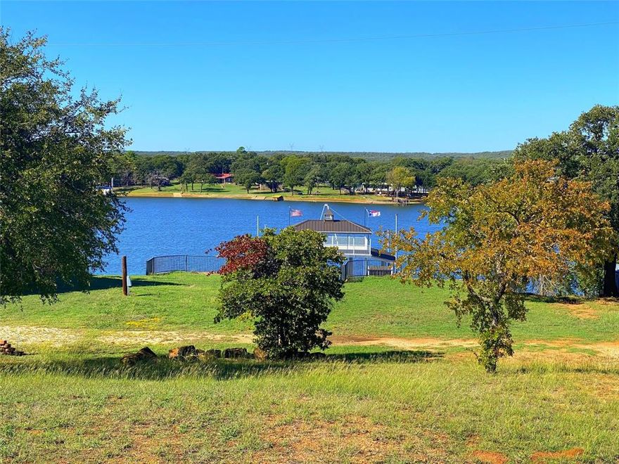 Beautiful waterfront lot on Amon G. Carter Lake. This is an excellent lot to build your home with coop water & electricity already in place. The property has beautiful rock retaining walls with wrought fences and a to-die-for aluminum Wahoo Dock. The 2 story dock includes 2 boat slips with Hydro Hoist Lifts, one being 25' x 10' & the other being 30' x 11'. There is also 2 covered personal watercraft lifts, a 19' x 20' covered sitting area with fishing floor and a 4' x 8' storage room with a roll up door. The second story is 24' x 30' with 16' x 30' being covered & also a trapeze swing for the water enthusiast. THIS IS A RARE FIND!