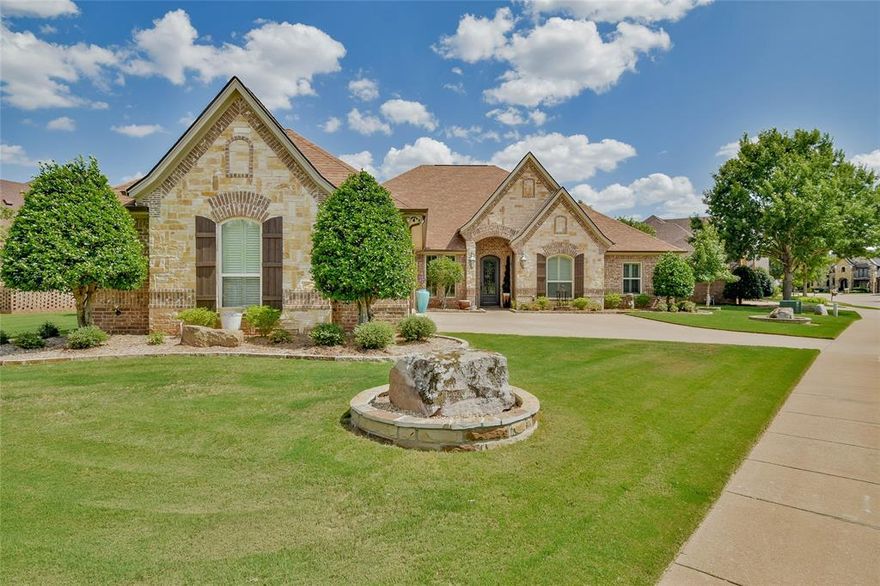 Welcome to this stunning custom Couto home located in the highly sought-after Islands of Lake Granbury. This 4-bedroom, 3-bathroom residence with a 3-car garage offers the perfect blend of luxury, comfort, and waterfront living. Inside, you are greeted by rich wood and tile floors flowing throughout, highlighted by coffered ceilings with wood beams that bring warmth and elegance. Just off the entry, the front room makes an ideal office with stained trim and double doors for style and privacy. The gourmet kitchen showcases a massive island, abundant cabinetry, and flows seamlessly into the dining area, where a designer light fixture sets the tone for memorable gatherings. A wall of windows along the back is fitted with electric shades, framing beautiful lake views at the touch of a button. The oversized primary suite is a true retreat, featuring a spa-like bathroom with dual vanities, his and her closets, and a large walk-in shower. Each of the three bathrooms is equipped with a bidet toilet, adding comfort and modern convenience throughout the home. Step outside and experience your own private resort. The back patio features vaulted ceilings with wood beams, flagstone decking, retractable shades, and multiple seating areas. Enjoy evenings by the fireplace, grilling at the built-in outdoor kitchen and bar, or relaxing in the pool and spa overlooking the water. A private 23 ft boat dock with a lift for double jet skis ensures lake life is always at your doorstep. The 3-car garage comes complete with cabinetry and an attic lift system, making storage and access simple and efficient. This home is the perfect combination of elegance, thoughtful design, and the best of Lake Granbury living.