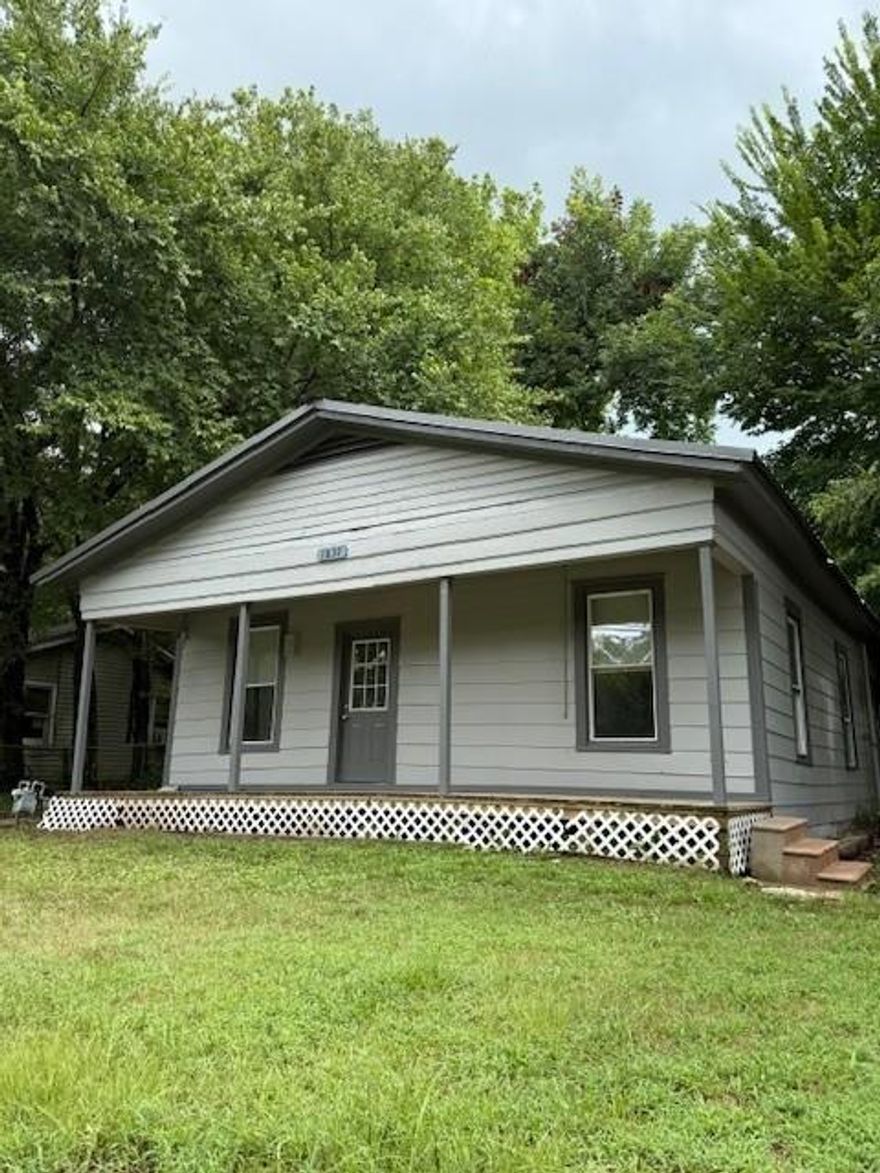 1950's style home on deep lot in NW Paris, Texas.  Great potential for investment!!!   2 large bedrooms, living room and dining room.  Typical of the era, rooms are almost square, spacious rooms and join door to door with small hallway. Kitchen has breakfast room and opens into the dining room.  Huge bonus room on the back with laundry hookups would make a great playroom or game room.  Home sits on a large city lot with partially fenced back yard.  Recent updates include new interior paint and vinyl plank flooring.