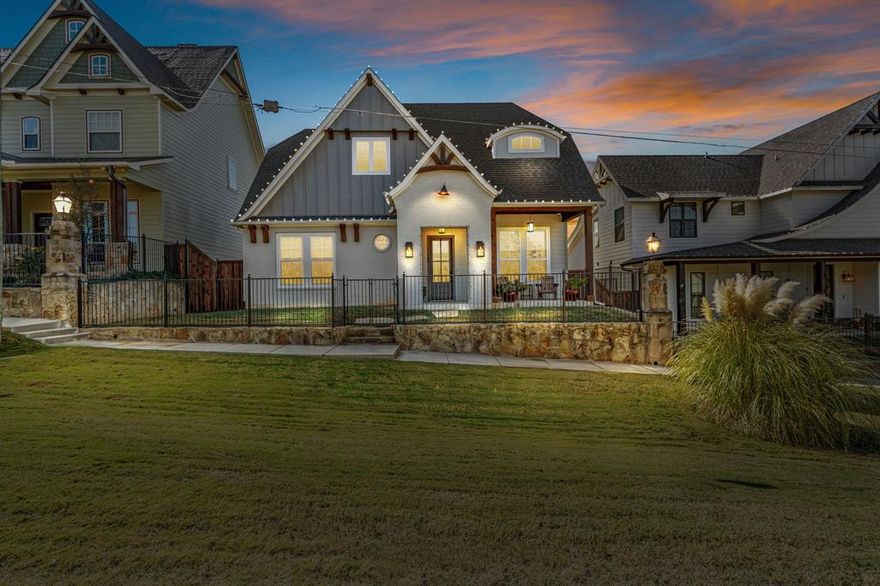 Stunning Argyle residence that perfectly blends timeless curb appeal with refined, modern design. From the moment you arrive, you’ll be captivated by the beautiful row house like exterior, welcoming front porch, and impeccable curb appeal. Step inside to find warm hand-scraped wood flooring, custom lighting, and wood beam accents throughout. The open-concept living area is flooded with natural light from large picture windows overlooking the backyard oasis, and features a cozy fireplace that anchors the space. The chef-inspired kitchen is equipped with quartz counter-tops, a built-in commercial-size refrigerator, stainless steel appliances, and a 5-burner gas cooktop with a custom-faced vent hood. Entertaining is effortless with the massive kitchen island, extended butler’s pantry, large walk-in pantry, and built-in buffet in the dining area. A dedicated home office offers built-in floor-to-ceiling cabinetry and shelving, providing both function and style. The split-bedroom layout ensures privacy, with spacious secondary bedrooms. The primary suite is a true retreat—featuring a massive bedroom, spa-like en-suite bathroom with a stand-alone soaking tub, oversized walk-in shower, separate his-and-hers vanities, and a huge walk-in closet designed for organization and luxury. Step outside to your own private paradise. The backyard features a sparkling heated pool and spa combo, built-in kitchen with grill and fridge and a covered sitting area with custom roller shades that can fully enclose the space—perfect for year-round relaxation and entertaining. This home is where craftsmanship meets comfort, offering a lifestyle of beauty, convenience, and sophistication—all in the heart of Argyle. Cameras throughout and camera DVR will convey with home, along with 24kW whole home generator. Energy efficient and soundproof with spray foam insulation throughout.