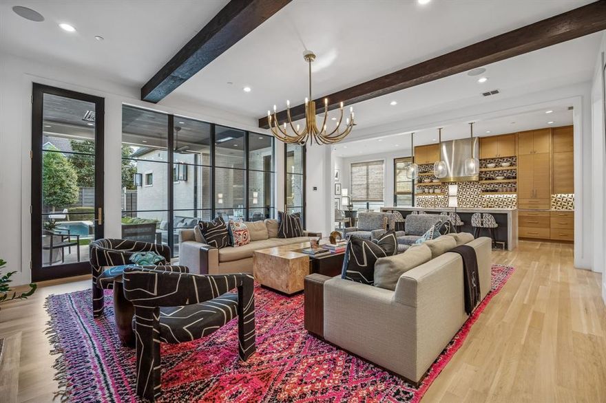 Stunning custom construction in the heart of University Park, zoned to Hyer Elementary, where timeless architecture meets effortless modern living. Built by Faulkner Perrin Custom Homes and designed by Studio Thomas James, this 5,336 SF residence offers a rare blend of quality, style, and functionality. A fully brick exterior and reinforced steel construction set the tone, while expansive 10-foot windows flood the first floor with natural light. White oak hardwoods and a striking herringbone entry lead into beautifully curated interiors designed for both everyday living and entertaining. The chef’s kitchen anchors the home with a 48” Wolf range, Sub-Zero column refrigerator and freezer, dual dishwashers, a 5’ Galley workstation sink, and leathered quartzite countertops. It opens seamlessly to the living and dining areas, complemented by a wet bar with wine refrigerator, beverage center, and ice maker—ideal for hosting. The primary suite offers a private retreat with vaulted ceilings, wood beams, a spa-inspired bath with a steam shower, and generous his-and-her closets. Upstairs, enjoy a media and golf simulator room, a private gym with sauna, and flexible living spaces.  Outdoor living shines with a covered patio featuring phantom screens, heaters, and built-in comfort elements, overlooking a resort-style pool and spa with a water feature. A fully equipped outdoor kitchen with Santa Maria and Yoder grills enhances year-round entertaining.  Additional highlights include smart home integration, Lutron lighting, whole-house audio, motorized shades, and thoughtful storage throughout. A rare opportunity to own a turnkey, design-forward home in one of Dallas’ most sought-after neighborhoods.