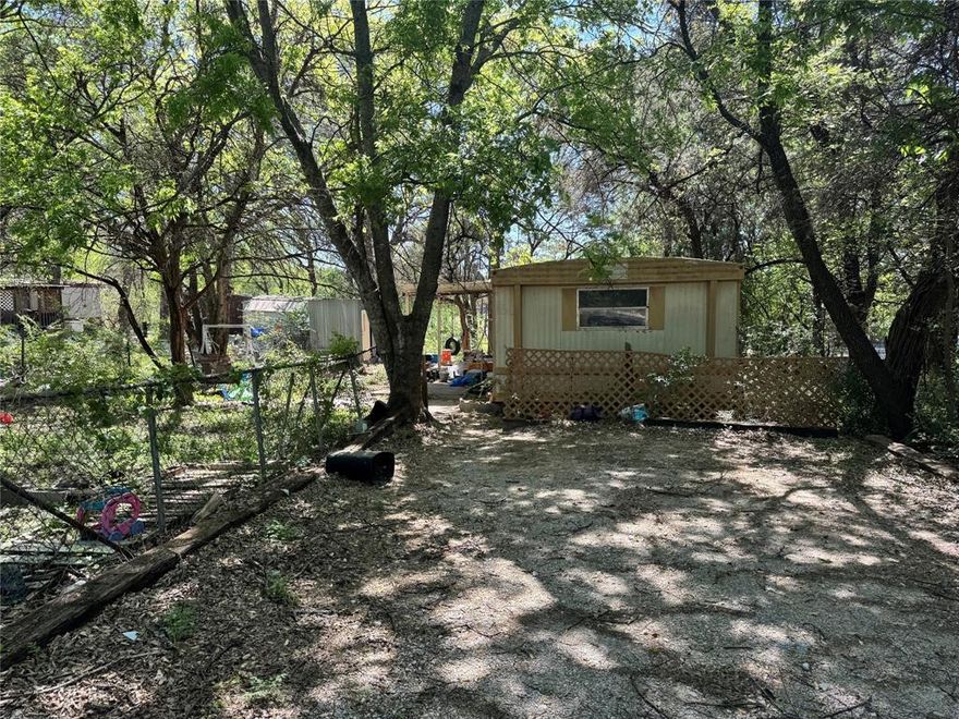 Investor Special.  This is a 2-bedroom, 1 bath single wide located in Oak Trail Shores.  You could live on Property, with a few repairs.   With the right vision, you could make this property a beautiful home.  The property has good bones.  Just needs the right person to put it back in tip top shape.  This subdivision offers a swimming pool, boat dock, fishing pier, parks, and a basketball court.  The electric is off, so carry a flashlight to view property.  Owner not responsible for any accidents while viewing the property.