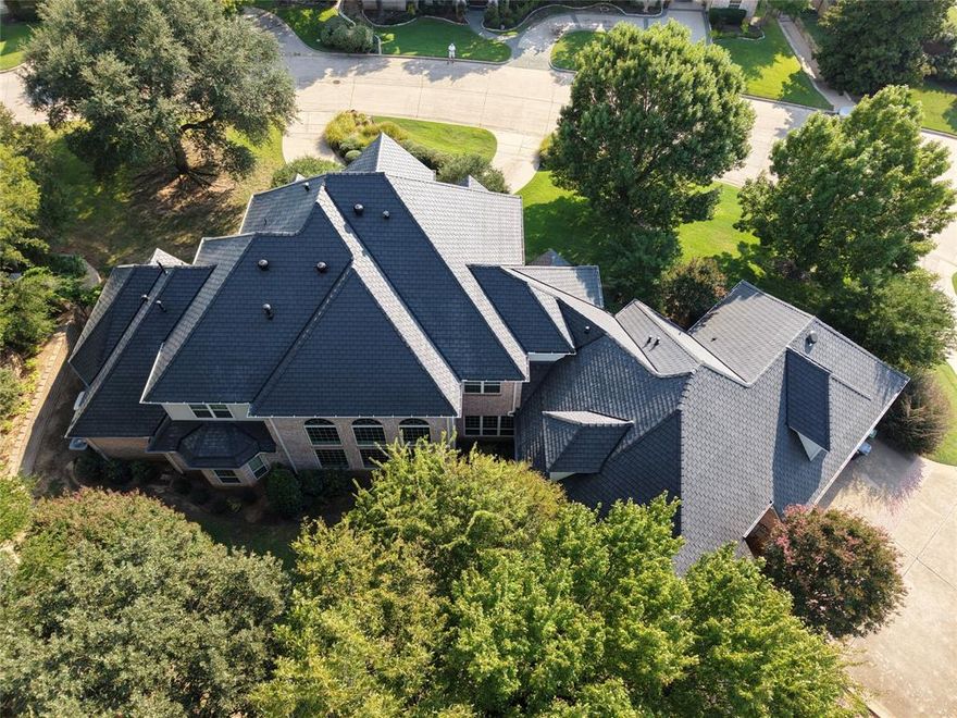 Cozy gated community! This prestigious, Move-in Ready residence rests on nearly an acre of manicured grounds, is highlighted by a circular drive, a secondary driveway, and an oversized three-car garage. A dramatic entryway with 23-foot ceilings and marble flooring introduces a formal dining room framed by stately columns, flowing seamlessly into the expansive family room and chef’s kitchen with adjoining dining areas. A butler’s pantry provides added storage and enhances entertaining with practical elegance.
In 2015, the home was thoughtfully expanded to include a spacious family room, private office, exercise room, functional storage, and an additional bath—providing valuable living area not reflected in public records.
Recent upgrades elevate the property’s appeal: a DaVinci Class 4 slate roof (installed 2025), new gutters and garage doors, new carpet upstairs and in downstairs bedrooms, upgraded remote-controlled exterior lighting, designer-inspired interior and exterior paint, and energy-efficient LED recessed lighting throughout. The chef’s kitchen boasts Kohler sink, a Sub-Zero Wolfe refrigerator with custom cherry panels, and an ASKO dishwasher. Renovated baths feature premium soft-close cabinetry, granite countertops, updated hardware, and a comfort-height commode in the primary suite. Elegant framed vanity mirrors convey with the home.
Mechanical highlights include five HVAC units (three Carrier systems 2021; two Lennox systems 2015), three water heaters (2024), full spray-foam insulation, and a Generac generator with a 10-year warranty. Other amenities:an air-conditioned,carpeted bonus room with plumbing in place—ideal for recreation,custom storage, or future conversion to living space.
With meticulous professional maintenance performed inside and out by the same trusted firms involved in the home’s original construction—along with thoughtful updates throughout, this residence offers true move-in readiness and lasting peace of mind for its next owner.