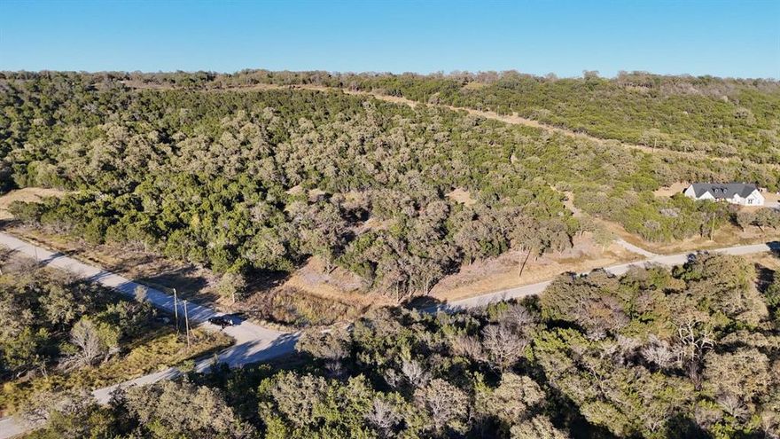 Welcome to your own wide-open piece of Texas in the beautiful Brazos Mountain Ranch community near Mineral Wells. This Tract is the perfect blank canvas for your country dreams. The land offers gently rolling terrain with plenty of usable space, ideal for building your dream home, a weekend getaway, or simply enjoying the peace and quiet that only the country can provide. Here, you’ll find room to breathe, wide blue skies stretching in every direction, and stunning sunsets that paint the horizon in color every evening. Brazos Mountain Ranch is a private, gated community designed for those who appreciate the outdoors and the slower pace of country living. Residents enjoy private river access to the Brazos River, a friendly rural atmosphere, and the kind of natural beauty that reminds you daily why Texas living is second to none. Whether you want to keep horses, raise a few animals, or just relax surrounded by nature, this property provides endless possibilities. Located just a short drive from Mineral Wells and Palo Pinto Lake, you’ll have access to local dining, shopping, and recreation while still feeling miles away from the noise of the city. With the right mix of open space and community, this property invites you to build, explore, and make lasting memories under the Texas sky. Come see what makes Brazos Mountain Ranch so special — and picture your next chapter beginning here.