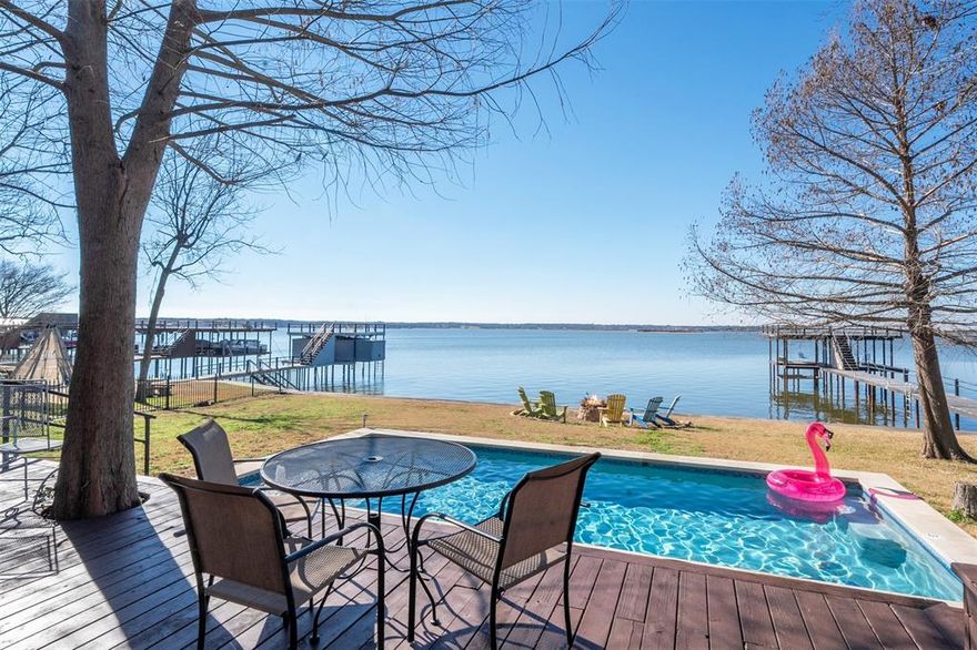 Experience unforgettable lakefront living on the wide open waters of Cedar Creek Lake in one of the area’s most sought-after neighborhoods. With 110 feet of shoreline and amazing open water views, this 4 bedroom, 2 bath retreat is fully furnished and ready for Spring.

The open-concept layout is ideal for entertaining, featuring rich solid oak flooring, granite countertops, and expansive wall-to-wall windows that frame breathtaking sunset views over the water. The spacious primary suite offers a private escape, while the oversized bunk room provides the perfect space for hosting family and guests, because lake memories are best shared.

Step outside and the lifestyle truly begins. Relax on the large covered porch, take a dip in the pool, or unwind in the hot tub as the sun dips below the horizon, or entertain effortlessly on the oversized party deck perched above the water. Double deck boat dock with boat cradle, PWC lifts, and 110 feet of capped steel retaining wall, ready for endless days on the lake.

Conveniently located just minutes from shopping and restaurants, and only a few doors down from the neighborhood park, this property offers the perfect balance of peaceful waterfront living and everyday convenience.

This is more than a home, it’s a front-row seat to open water, spectacular sunsets, and the lake life you’ve been dreaming about. Don’t miss your opportunity to own one of the best views on Cedar Creek Lake.