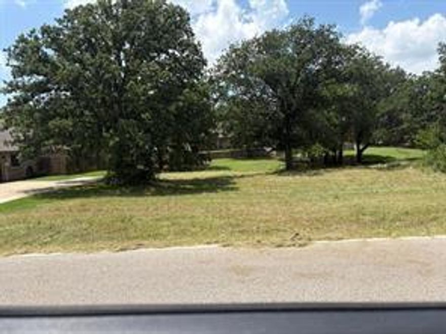 Seller is really motivated to sell fast , Located in the heart of Pecan Plantation, this generous one-third acre lot is the perfect place to build your dream home. Bring your builder and plans—this property is ready for someone with a vision. Set within a secure, gated community along the Brazos River and near Lake Granbury, Pecan Plantation offers a lifestyle unlike any other. Residents enjoy access to a private marina, championship golf course, multiple swimming pools, tennis courts, walking trails, a shopping center with its own grocery store, an on-site gas station, and even a private airport. For aviation enthusiasts, some lots near the airport allow for private hangars alongside your home. Select properties also permit RV garages, offering great flexibility. Utilities are convenient, with water and cable at the front of the lot, and septic needed. This is a rare chance to own land in one of Granbury’s most unique and amenity-rich communities.