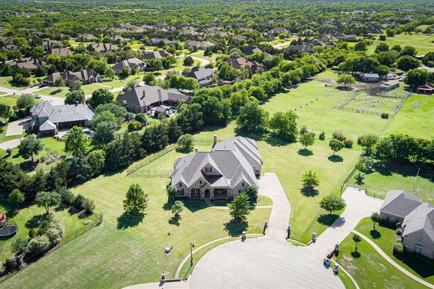 This lovely Paul Taylor home exemplifies Lucas Living! Located in a cul-de-sac and quietly situated at the back of Broadmoor Estates, this lot backs up to a horse farm where you can see and enjoy horses while you sip your coffee from the gorgeous covered brick patio. Sprawling one story floorplan offers so many amenities such as walk in closets in every bedroom, gorgeous hardwood floors, an owners suite that is the full length of one side of the house and a spacious walk-in holiday storage room that could also make a fantastic Peloton room. The game room and media room are the perfect place for entertaining or having a movie night! Oversized 4 car garage with over 1300 sq.ft. of decked attic space. Cook to your heart's content in this kitchen taking center stage with stainless appliances, 6 burner stove with pot filler, rollout cabinet drawers in the solid wood cabinetry and more! Install a tv at the mantle on the patio to watch the games! Plumbed for outdoor shower! R38 Insulation!