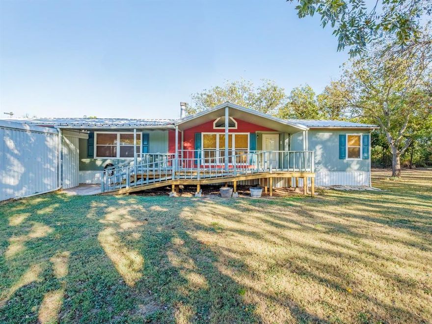 Sitting on 0.79 acres, this 4 bedroom, 2 bath manufactured home offers space and versatility with 2 living rooms and an office that can serve as a 5th bedroom if needed. The home provides 2,128 sq ft of living space, featuring a fireplace, carpet and vinyl laminate flooring, and a comfortable flow throughout. Enjoy outdoor living with both a front and back porch, along with a deck for relaxing or entertaining.

The property includes 12 mature pecan trees and 1 apricot tree, adding shade and seasonal harvests. A water well offers self-sufficient water access, and the 2-vehicle carport provides covered parking. This is a quiet setting with room to spread out, garden, or simply enjoy the open space. A practical property with a cozy feel and functional layout—ready for its next owner.