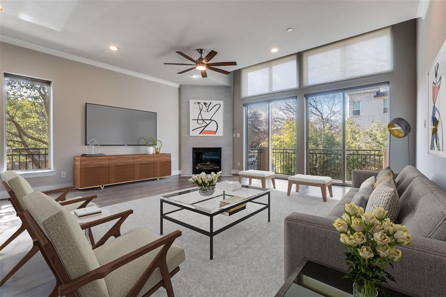 This beautiful East Dallas condo, located in an intimate six-unit building, offers an ideal location, walkable to Lakewood shopping and dining. Thoughtfully designed for both everyday living and entertaining, the floor plan is enhanced by the premium placement of this end unit, providing abundant windows and exceptional natural light in every room.

Gorgeous newer hardwood floors run throughout the home. The second floor serves as the heart of the residence, featuring spacious open living, dining, and kitchen areas that create a seamless and inviting environment. This level is further complemented by a fireplace, a step-out balcony, and an additional balcony large enough for comfortable seating—perfect for entertaining or relaxing outdoors.
The primary suite on the third floor offers a private retreat with a large walk-in closet and a well-appointed bathroom featuring dual sinks, a separate jetted tub, and a walk-in shower. A second bedroom with an attached bath is located on the first floor, ideal for guests or added privacy. Flexible spaces on the third and fourth floors provide excellent options for additional living areas, home offices, or workout spaces.

Crowning the home is a spacious rooftop balcony—an ideal spot to unwind and enjoy sunset views. HVAC systems were replaced in September of 2023. The attached two-car garage has a rear-entry.  This home blends convenience, comfort, and style.