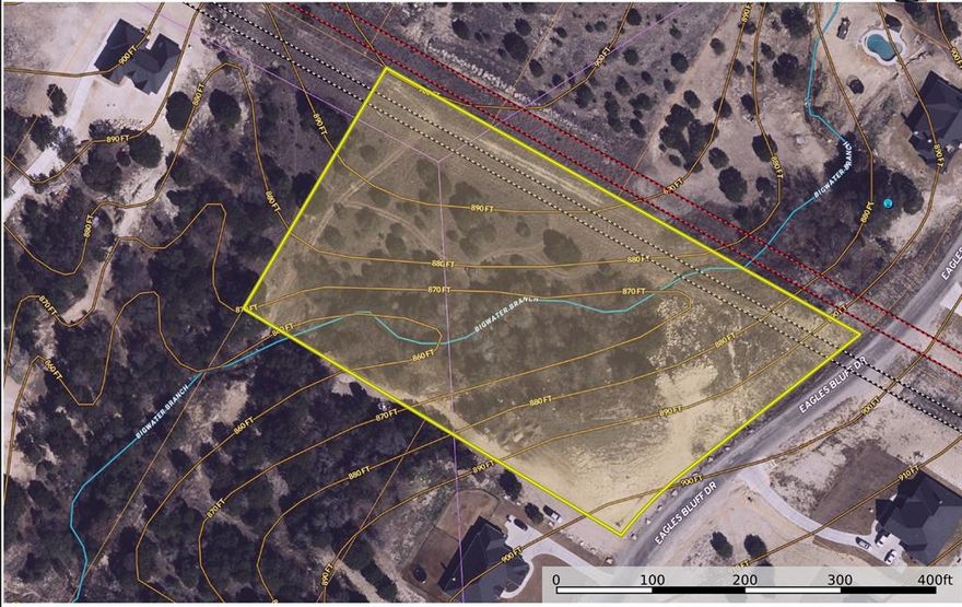 Discover the best of both worlds on this beautiful 3.5± acre homesite in the Gated Eagles Bluff community—where privacy, flexibility, and lifestyle come together. Deed restrictions allow for a primary residence plus a second structure with a minimum of 500 sq ft, making this property ideal for multi-generational living, guest quarters, a private office, or studio space.

Enjoy county taxes, well water, and the freedom of space without sacrificing convenience. The land offers natural character and elevation, creating an exceptional setting to live, work, and play—whether that means quiet mornings at home, outdoor recreation, or hosting family nearby with independence and comfort.  Bigwater Creek runs through the property, featuring a natural underground spring, a picturesque waterfall, and a small fishing hole. This unique water feature enhances the land’s character, supports native wildlife, and creates a peaceful setting rarely found on build-ready acreage. A special blend of natural beauty and usable land—ideal for those seeking a private retreat with year-round enjoyment.
Located within the highly acclaimed Brock ISD, this property provides a rare opportunity to build your custom vision in an area known for strong community and top-tier schools. Bring your builder and create a legacy property that adapts to every stage of life.

Gated community • Custom-build ready • Multi-gen friendly • Picturesque mini waterfall