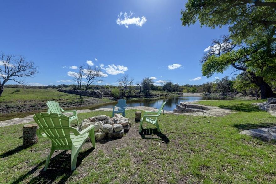 Live Water: The ranch boasts a clear and flowing creek, enhancing the landscape and providing a serene backdrop for over 1.5 a mile. Big Sky Views: Imagine waking up to panoramic vistas of rolling pastures, distant hills, and endless skies. Proximity to Fredericksburg: A mere 8-minute drive brings you to the heart of Fredericksburg, known for its wineries, charming shops, and rich history. Historic Rock Home: As you enter the property, you’ll pass an 1880s German-style rock home with timeless character. This detached guest suite offers a glimpse into the past. Primary Home Overlooking Bear Creek: Further down the drive, the main home awaits. Perched atop Left Bear Creek, it offers breathtaking views of the clear waters controlled by a three-tier dam system. Party Barn and Bunkhouse: Adjacent to the main home, a spacious 2,000+ sq ft party barn and bunkhouse beckon. Complete with a full kitchen and two generous bathrooms, this space is perfect for entertaining guests.