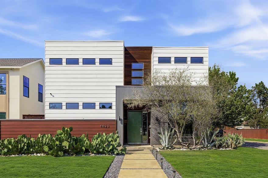 Sitting on a prominent corner lot in the Bird Streets, this striking contemporary home blends thoughtful design with effortless livability. Clean lines, expansive windows, and soaring ceilings create a light-filled interior anchored by white oak hardwoods and an open, flowing layout designed for both everyday living and entertaining.

The kitchen is the heart of the home, featuring a large waterfall quartz island, Bertazzoni range, sleek cabinetry, and seamless connection to both dining areas and the main living space. A dedicated wine wall adds a refined touch, while oversized sliding glass doors extend the living area to a covered patio—perfect for indoor-outdoor gatherings.

The flexible floor plan offers a primary suite and additional bedroom on the first floor, with a third bedroom, full bath, and office upstairs, along with a second living area. The primary suite is a true retreat, complete with a beautifully updated bath and custom closet.

Upstairs, access to the rooftop reveals a turfed outdoor living space with the opportunity to expand—ideal for taking in sunset views or creating a future extension of the home.

Extensively maintained and upgraded, the home includes refinished and expanded hardwoods, full interior repaint, motorized blinds, smart home features, solar panels, upgraded security system, and a fully redesigned landscape with native plantings. Major systems, including HVAC components, have been recently serviced and replaced.

Recent updates include: wood flooring added to primary bedroom, all wood flooring refinished, fence power-washed and stained, garage door systeme upgraded, fresh interior paint, updated security system, solar panels and more.