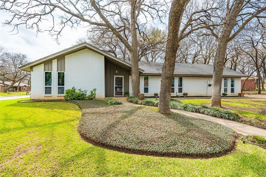 WHAT A HOME! This beautifully updated home has an incredible amount of space, tons of charm, modern updates, and an extra over-sized room that is perfect for a second primary bedroom or a game room! The expansive living areas with great natural light greet you as you enter the house and open up to the recently renovated kitchen with gorgeous quartz countertops, new backsplash, recently painted cabinets, new banquet seating in the breakfast room, and new floors that run throughout the house! The primary suite also recently underwent a breathtaking remodel of the primary bathroom with new vanity, flooring, and gorgeous tile shower! The elegance of the modern updates and the spacious living areas make this home ready to host your friends and family right away! There is an oversized laundry room with great built-in cabinets and space for an extra refrigerator that leads right into the 5th bedroom – 3rd living room. This extra room is so versatile, and it has an extra-large closet as well! So it could easily function as a second primary or even a mother-in-law suite since it has its own outside entrance. And all of that is just inside the house! Through the beautiful French doors to the backyard you will find a lovely patio, a great sized yard, and a large shed for storage! This beautiful corner-lot home has great trees and an absolutely perfect location in the city! Less than 8 minute walking distance to both Shackelford Junior High and to Lamar High School makes the commute for students a breeze! It is also only a 5 minute drive from both the Randol Mill Park and the River Legacy Park, where you can enjoy nature trails and bike trails all year round! Plus, it is just 8 minutes away from the AT&T Stadium as well! This home is truly one of a kind! Come take a look today!