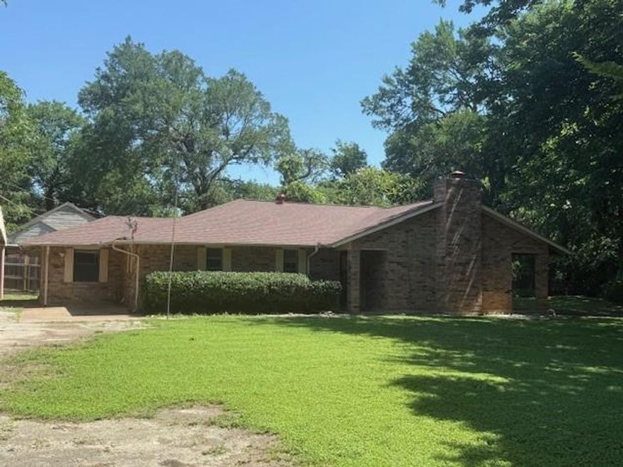 Here it is!  A hidden gem of a property in the heart of downtown Frisco.  Walking distance to every thing, but secluded from it all.  This home features 3 bedrooms with 2 and a half baths, large living area with warm paneling center around a brick wood burning fire place.  The home has lots of room and is situated on a great lot with beautiful trees and a creek along one side.  There is a one and half detached car garage, a huge shed and a two car carport.  This home has so many possibilities just bring your imagination.