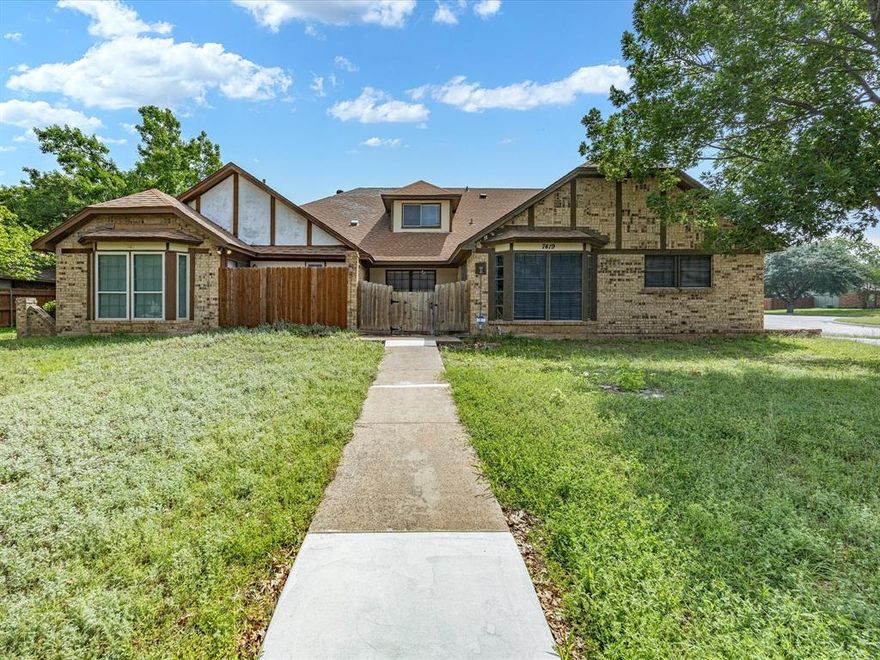 This spacious two-story half-duplex offers just over 2,000 square feet and a layout designed for flexibility and everyday comfort. Inside, the home features a generous living area with a brick fireplace and abundant natural light. New laminate flooring in the living room and primary bedroom adds an updated touch, while the flexible downstairs front room can easily function as a formal living area, dining room, sitting room, or home office depending on your needs. The dining space is highlighted by vaulted ceilings and large windows that bring in natural light and create an airy feel. The kitchen offers ample cabinet and counter space, room for daily meal prep, and easy flow into the main living spaces. The first-floor primary bedroom provides convenience and privacy, along with a spacious footprint that allows room for a sitting area or additional furnishings. Upstairs, two oversized secondary bedrooms offer versatility and include built-in desk space, making them well-suited for study, hobbies, or work-from-home setups. The floorplan provides separation between the primary suite and upstairs bedrooms for added flexibility. Outside, the property features a rear-entry garage, fenced backyard, and an enclosed covered patio area that can be used for relaxing or additional outdoor living potential. The corner-style positioning and mature surrounding trees add to the overall setting, while the location places you close to neighborhood green space and daily conveniences. Positioned near Candleridge Park, the home combines convenient access to neighborhood recreation with quick connections to shopping, dining, and entertainment throughout south Fort Worth. Nearby options include local parks, trails, recreation centers, Hulen Mall, Trinity Trails, and Benbrook Lake for outdoor enjoyment, boating, hiking, and weekend adventures. Additional recreation in the area includes South Creek Park, Westcreek Park, and Chisholm Trail Community Center.